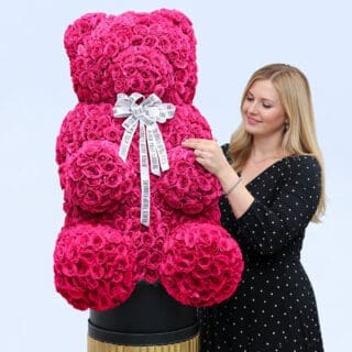 BTF Home 55 Pink spray roses in a teddy arrangement style, finished with a white ribbon.