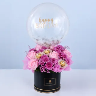 BTF Home 17 Pink-themed bouquet in a black round box featuring roses, chrysanthemums, Ferrero Rocher chocolates, and a balloon arranged as a luxurious celebration gift.